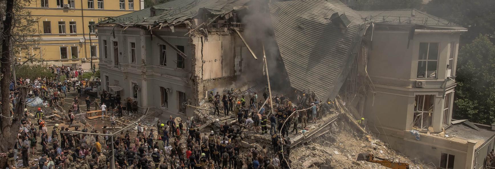Emergency and rescue personnel along with medics and others clear the rubble of the destroyed building of Ohmatdyt Children's Hospital following a Russian missile attack in the Ukrainian capital of Kyiv on 8 July 2024, amid Russian invasion in Ukraine.