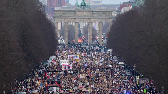 rotesters take part in a demostration under the motto 'Loud against Nazis' with the landmak Brandenburg Gate in the background in Berlin on February 2, 2025. 