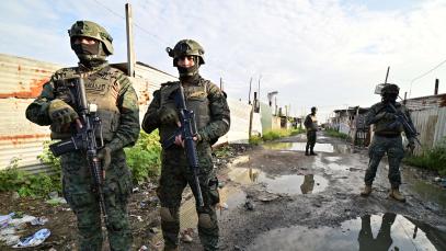 Ecuadorean security forces stand guard during the so-called Tormenta 22 operation, in which several houses used by organised crime gangs to keep kidnap victims isolated were destroyed, in Duran, Ecuador, on March 14, 2025. 