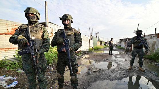 Ecuadorean security forces stand guard during the so-called Tormenta 22 operation, in which several houses used by organised crime gangs to keep kidnap victims isolated were destroyed, in Duran, Ecuador, on March 14, 2025. 