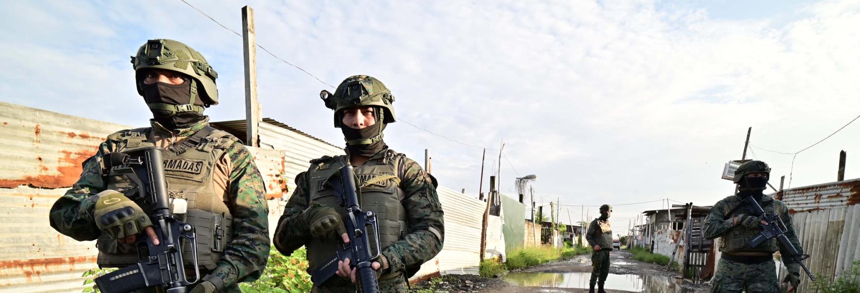 Ecuadorean security forces stand guard during the so-called Tormenta 22 operation, in which several houses used by organised crime gangs to keep kidnap victims isolated were destroyed, in Duran, Ecuador, on March 14, 2025. 