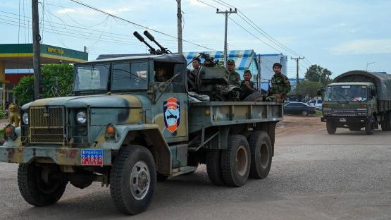 Cambodian soldiers stand on a military truck with an anti-aircraft gun in Oddar Meanchey province on 25 July 2025. 
